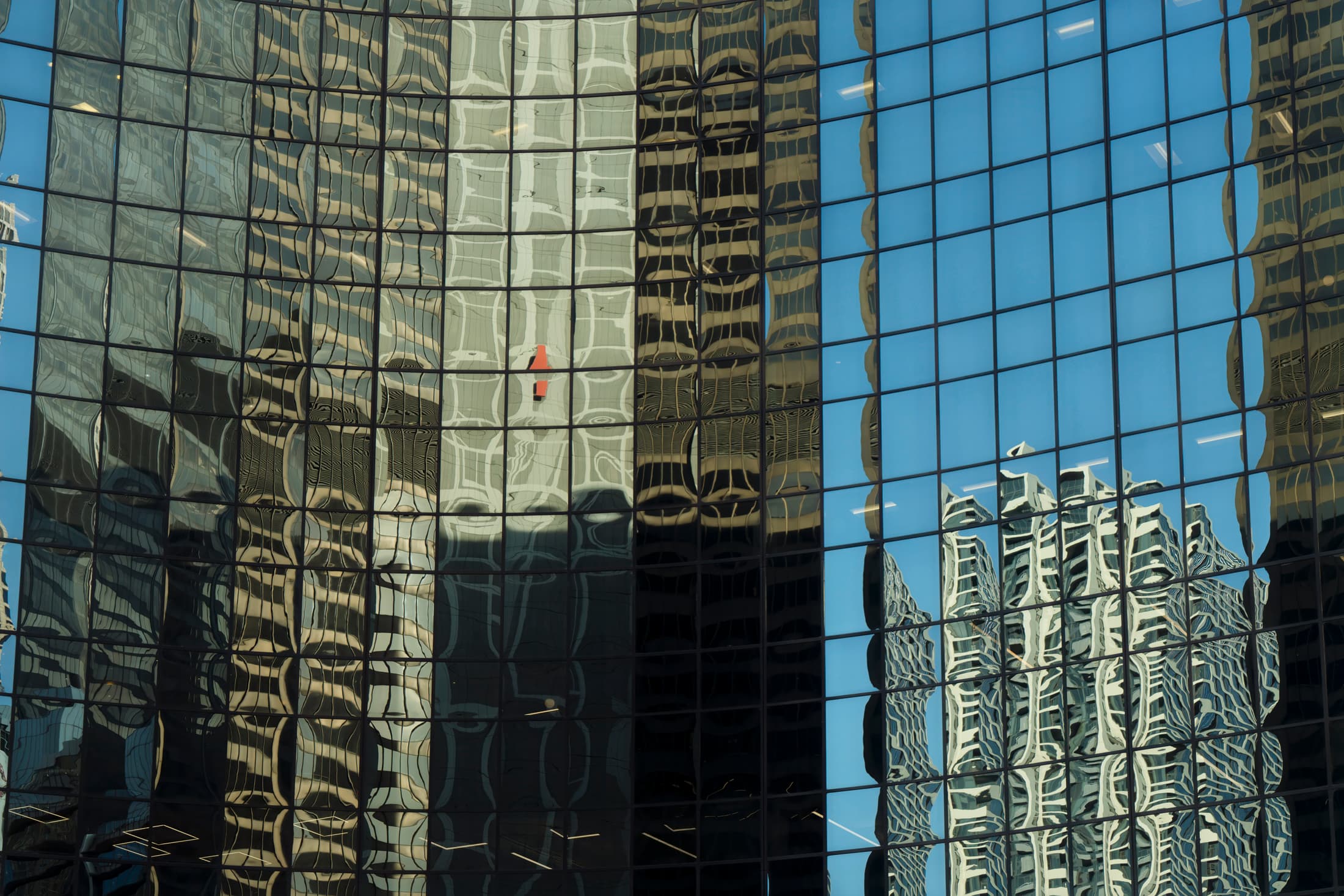 Chicago, Illinois. Brown, blue, and black reflections on geometric glass curtain wall. Reflections are of other buildings lining the Chicago River.
